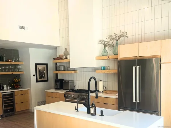 a kitchen with a refrigerator and cabinets