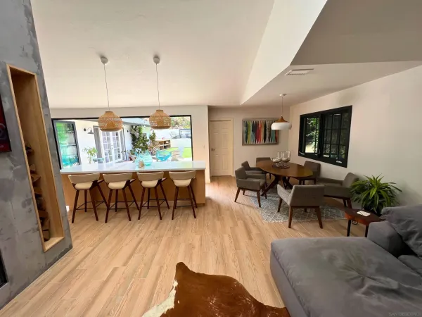 a living room with furniture wooden floor and dining room