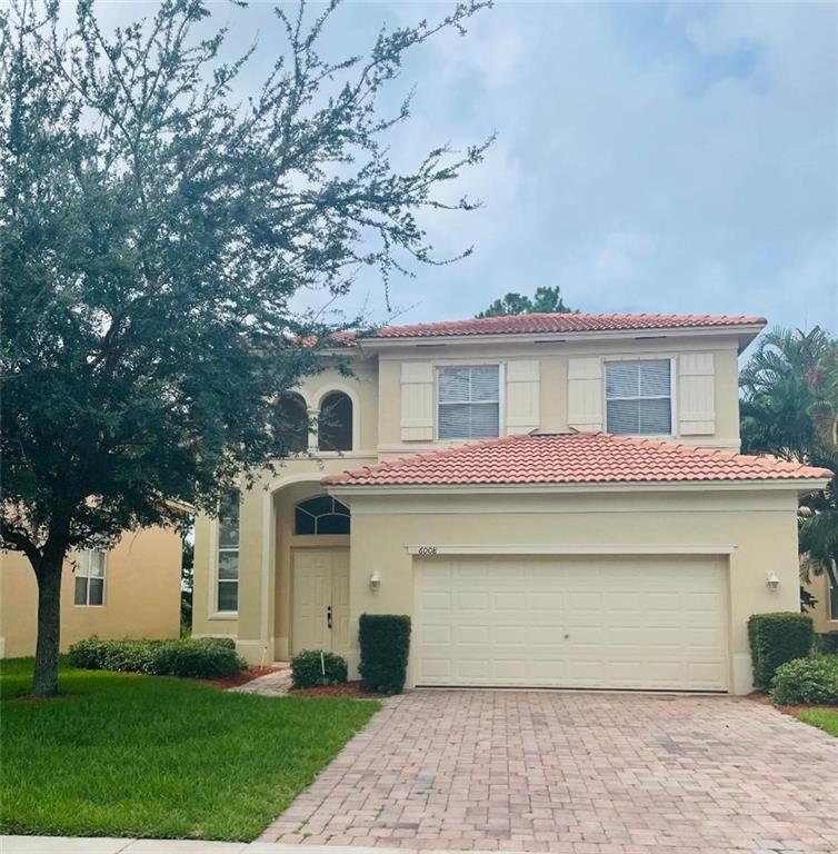 6008 Spring Lake Terrace Fort Pierce, FL 34951 - Photo 1 of 33 a front view of a house with garden