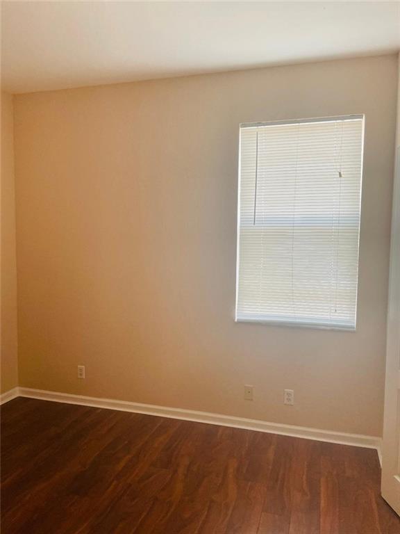 6008 Spring Lake Terrace Fort Pierce, FL 34951 - Photo 11 of 33 a view of an empty room with wooden floor and a window