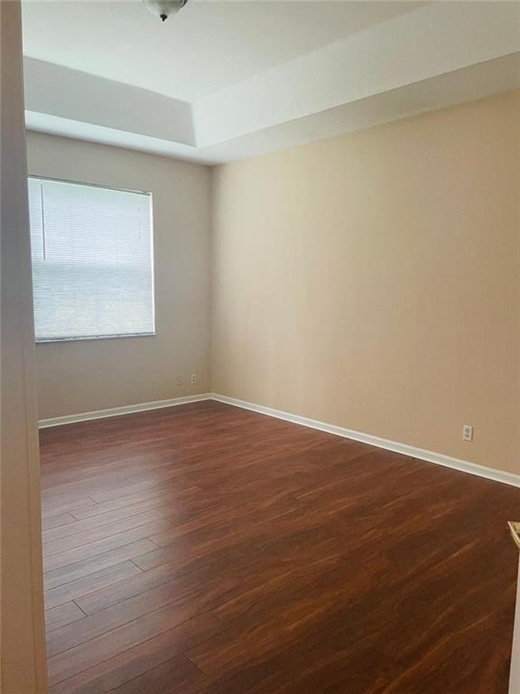 6008 Spring Lake Terrace Fort Pierce, FL 34951 - Photo 13 of 33 an empty room with wooden floor and windows