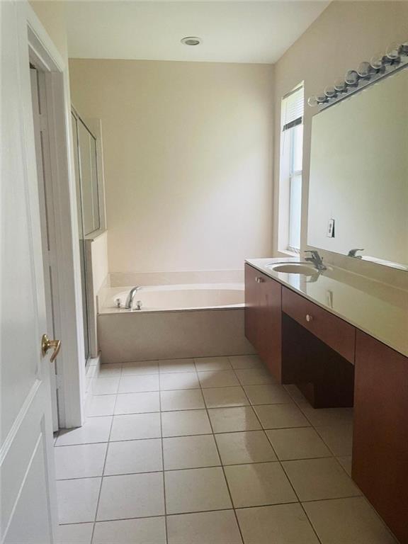 6008 Spring Lake Terrace Fort Pierce, FL 34951 - Photo 18 of 33 a bathroom with a tub shower vanity and a sink