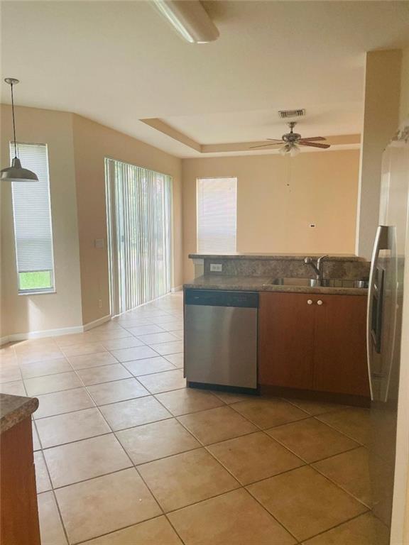 6008 Spring Lake Terrace Fort Pierce, FL 34951 - Photo 23 of 33 a view of a kitchen with a sink and a refrigerator