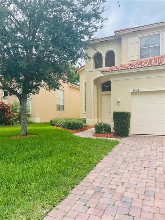 6008 Spring Lake Terrace Fort Pierce, FL 34951 - Photo 4 of 33 a front view of a house with garden