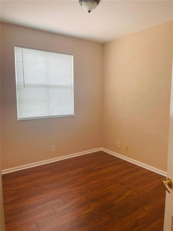 6008 Spring Lake Terrace Fort Pierce, FL 34951 - Photo 8 of 33 an empty room with wooden floor and windows