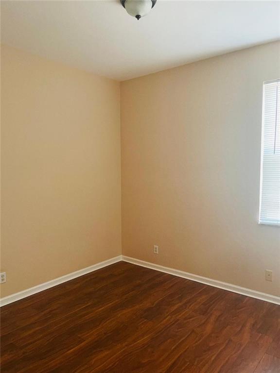 6008 Spring Lake Terrace Fort Pierce, FL 34951 - Photo 10 of 33 a view of an empty room with wooden floor and a window