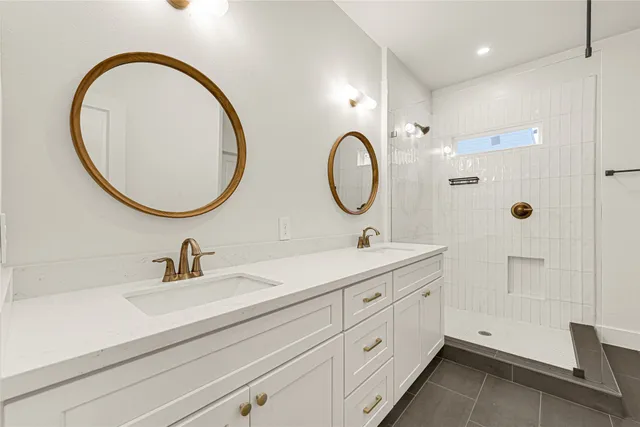 a bathroom with a double vanity sink and a mirror
