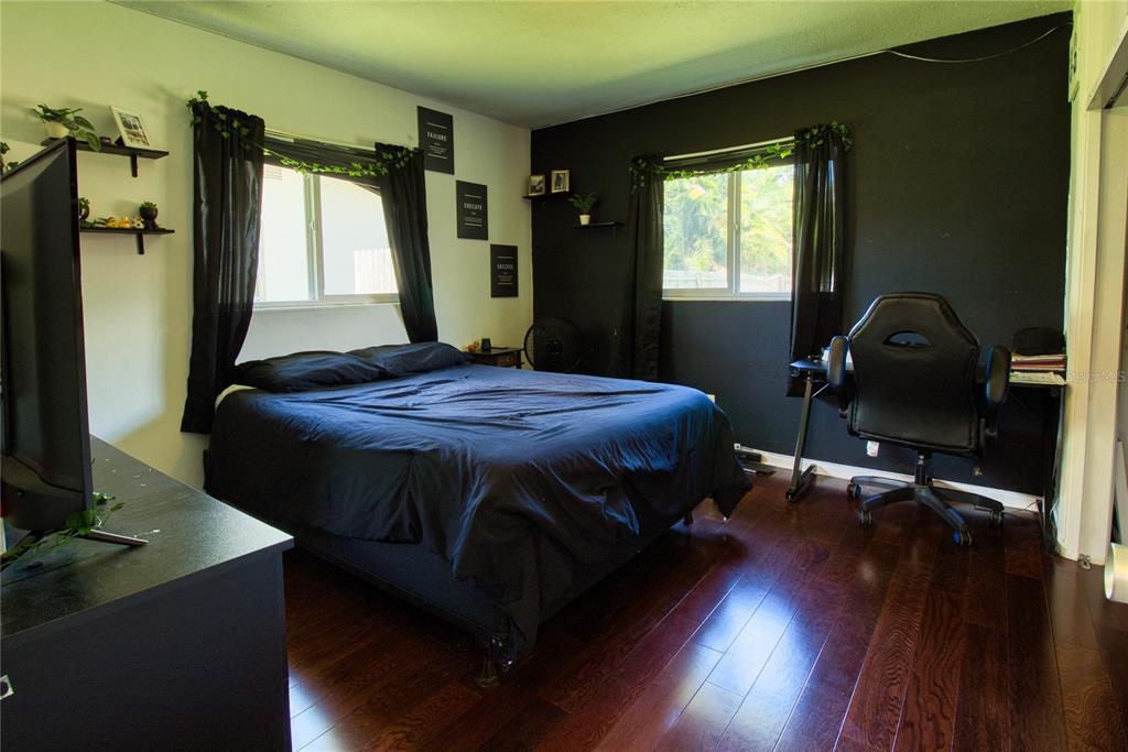 12784 137th Lane Largo, FL 33774 - Photo 11 of 14 a bed sitting in a bedroom next to a window