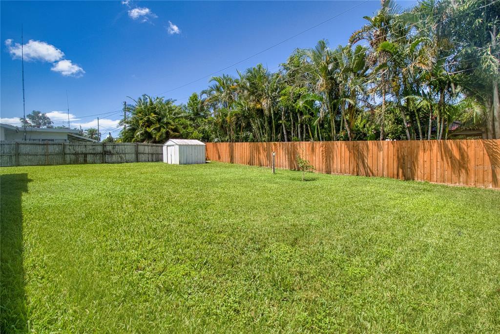 12784 137th Lane Largo, FL 33774 - Photo 14 of 14 a view of backyard with swimming pool and trees