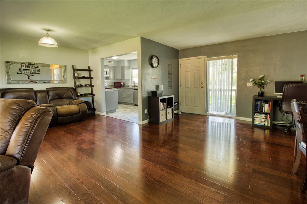 12784 137th Lane Largo, FL 33774 - Photo 4 of 14 a living room with furniture and a wooden floor