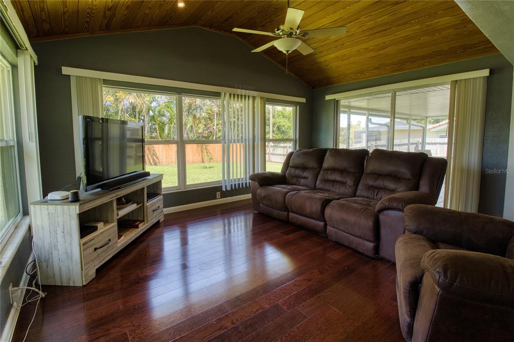 12784 137th Lane Largo, FL 33774 - Photo 6 of 14 a living room with furniture and a flat screen tv