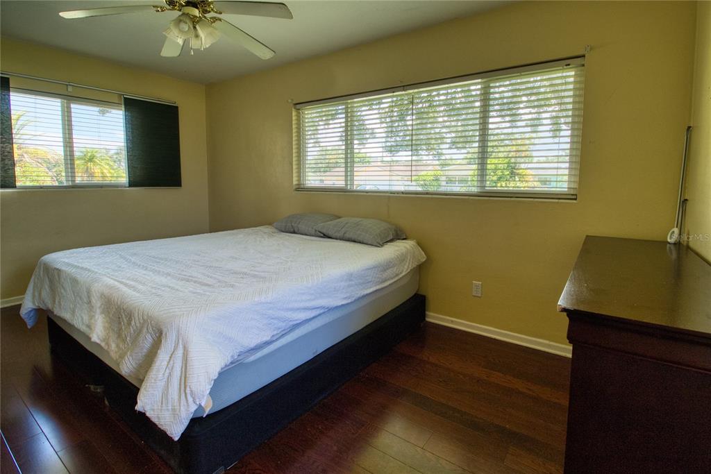 12784 137th Lane Largo, FL 33774 - Photo 10 of 14 a bed sitting in a bedroom next to a window