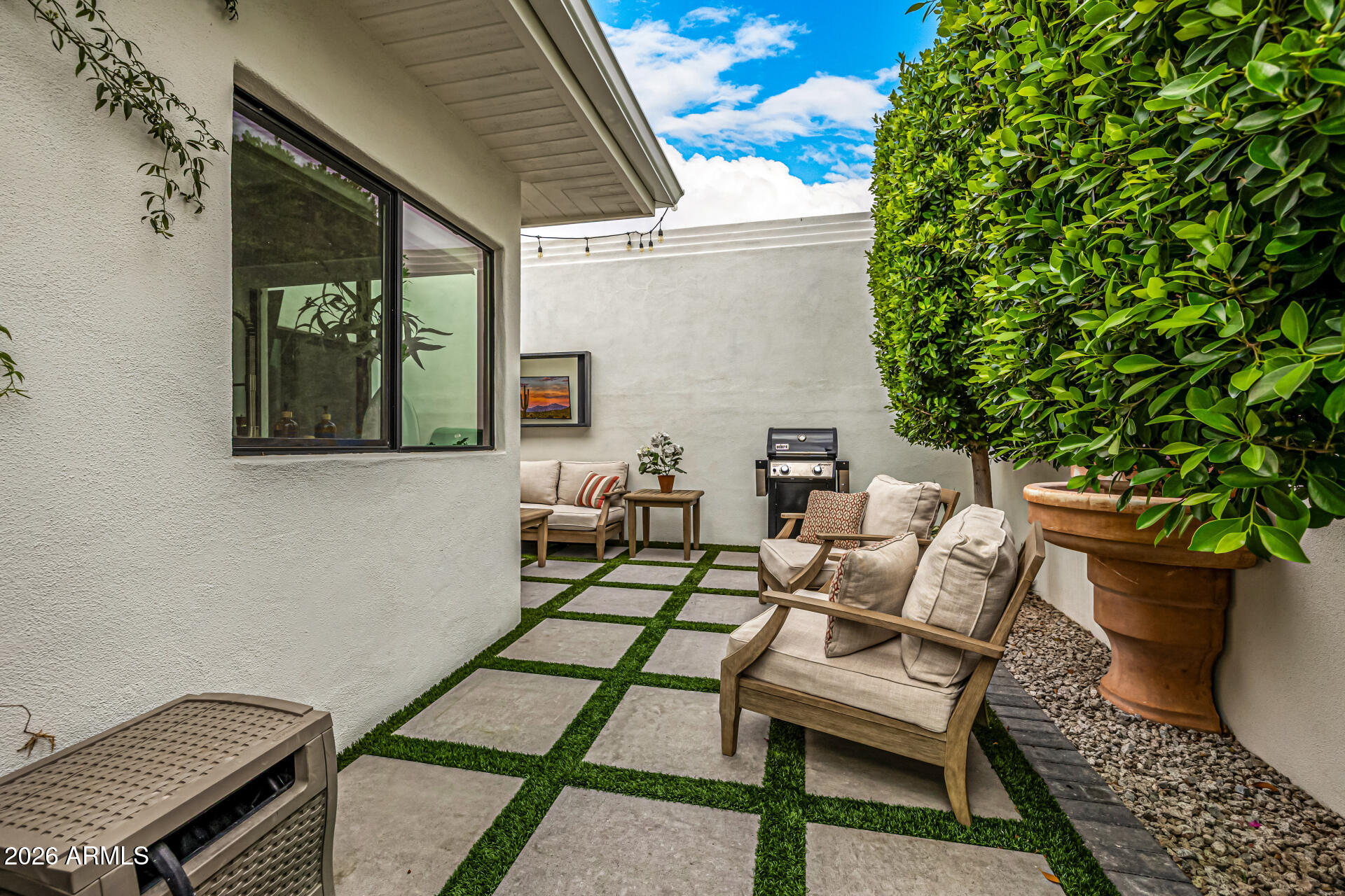 7770 East Camelback Road, Unit 11 Scottsdale, AZ 85251 - Photo 3 of 60 a backyard of a house with outdoor seating