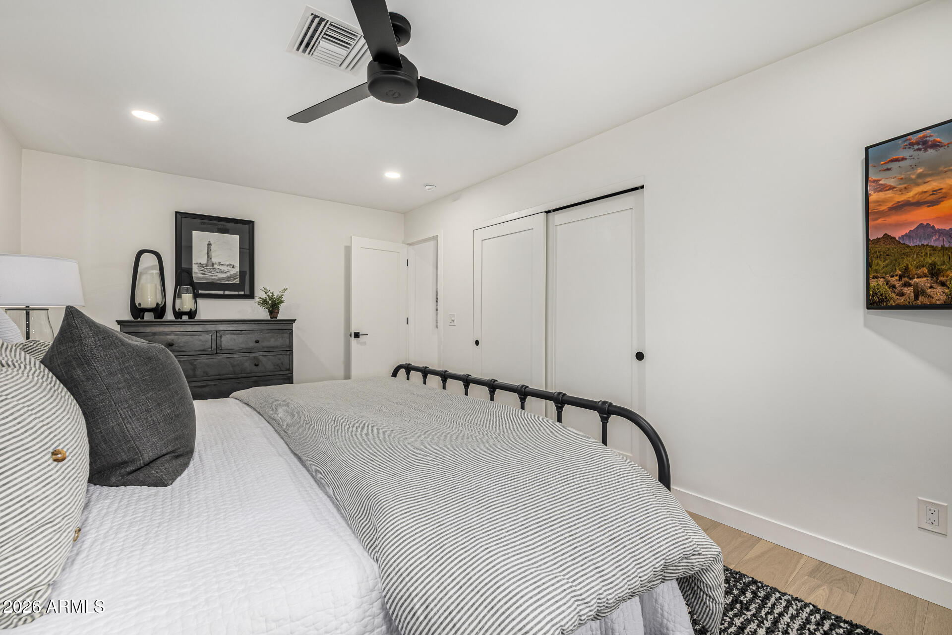 7770 East Camelback Road, Unit 11 Scottsdale, AZ 85251 - Photo 31 of 60 a bedroom with a bed and a chandelier
