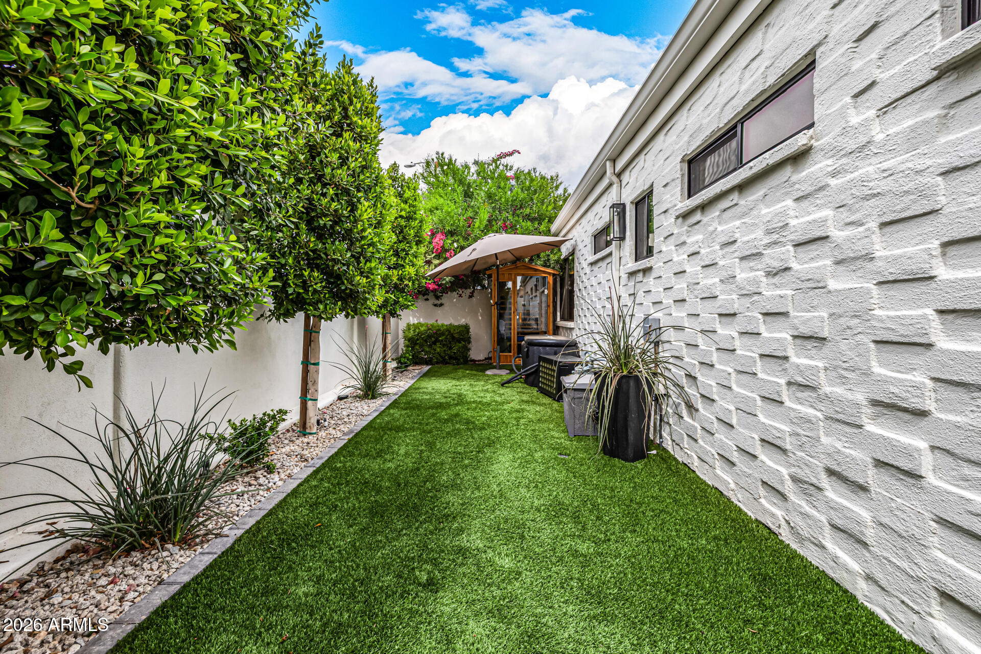 7770 East Camelback Road, Unit 11 Scottsdale, AZ 85251 - Photo 44 of 60 a view of a house with a yard