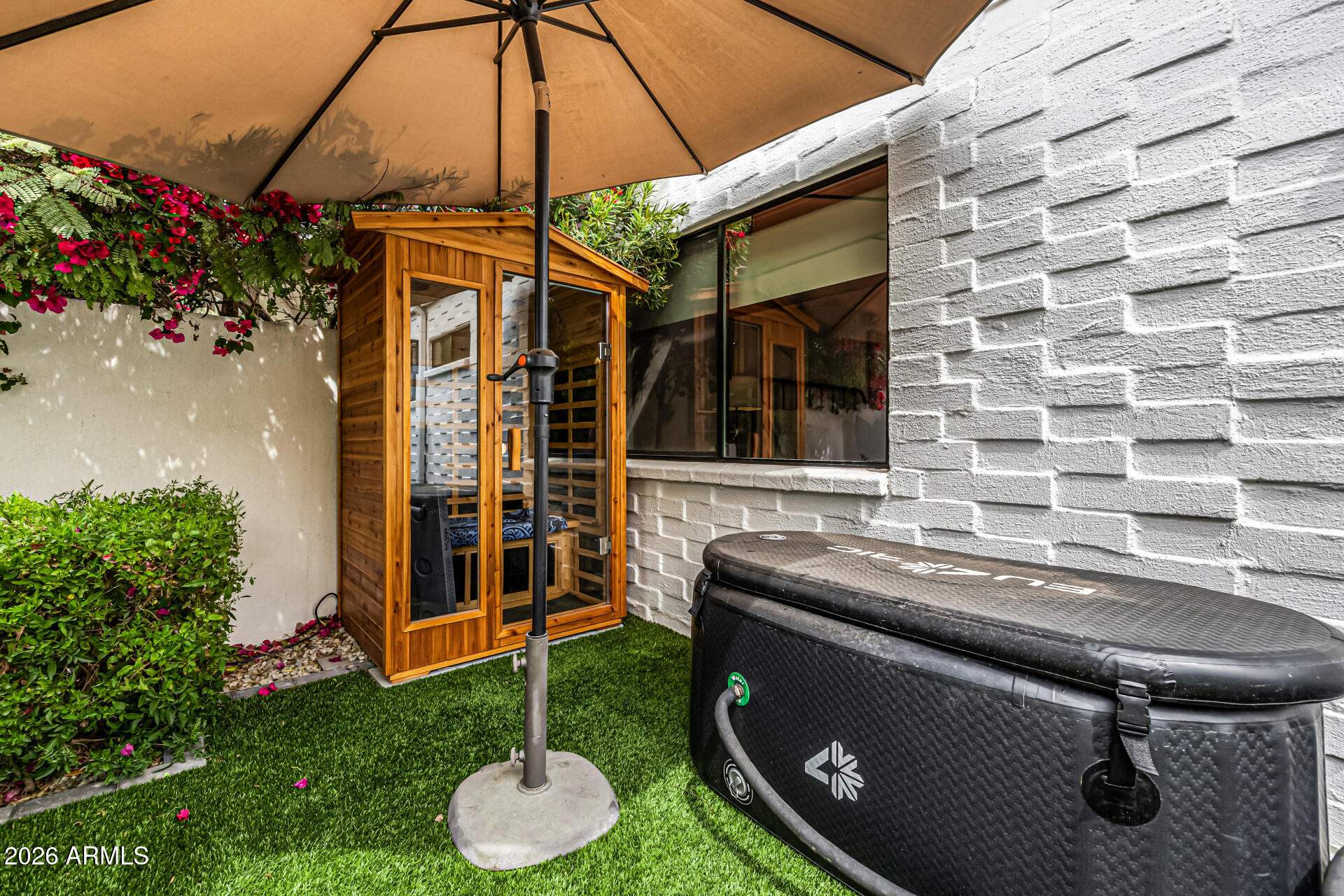 7770 East Camelback Road, Unit 11 Scottsdale, AZ 85251 - Photo 45 of 60 a patio with a table and chairs and potted plants
