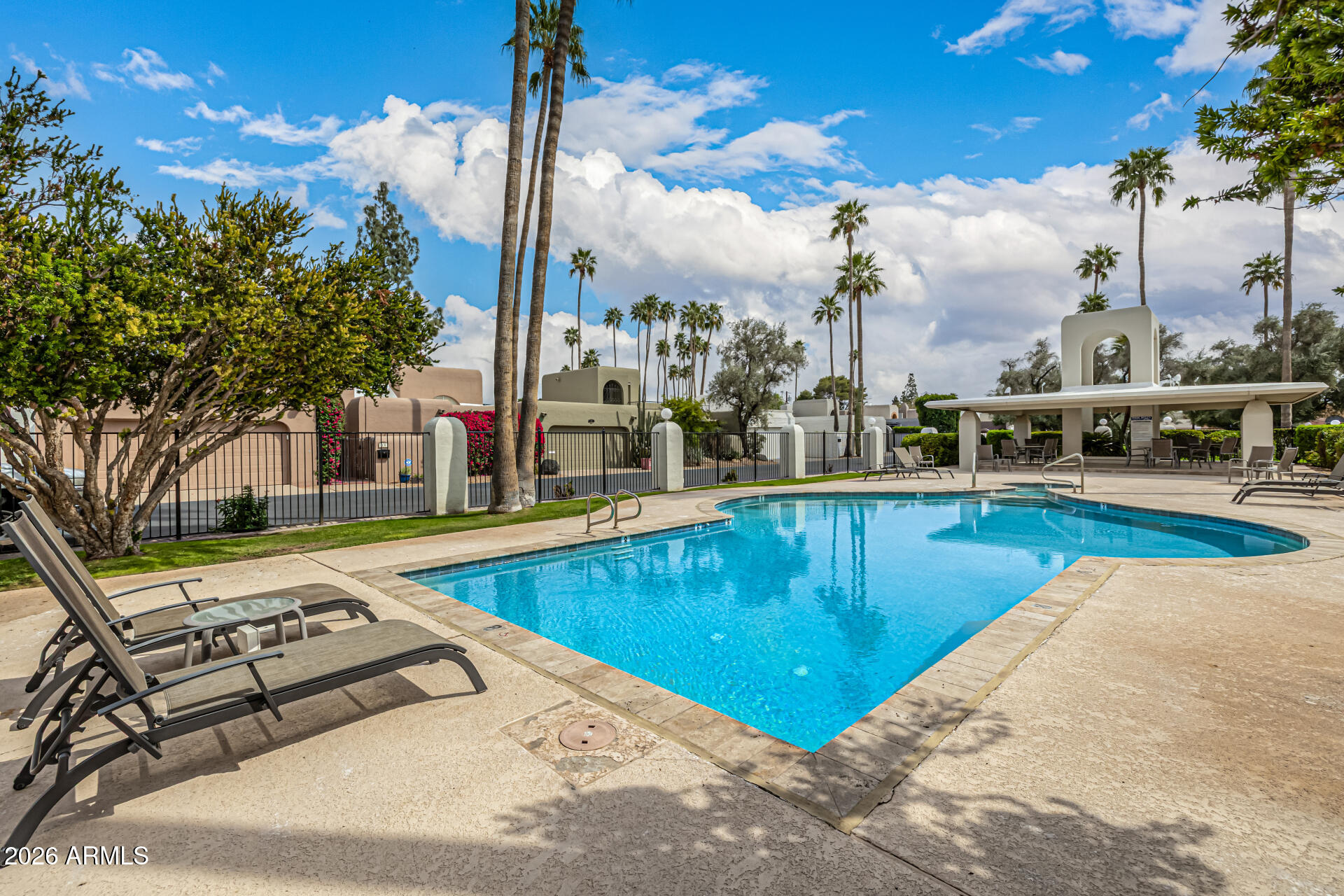 7770 East Camelback Road, Unit 11 Scottsdale, AZ 85251 - Photo 48 of 60 a view of a swimming pool with a lounge chairs