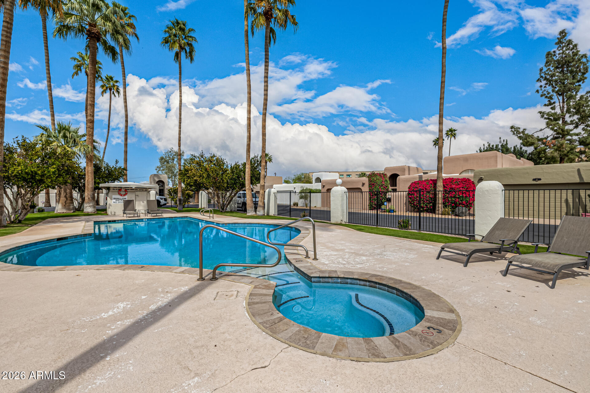 7770 East Camelback Road, Unit 11 Scottsdale, AZ 85251 - Photo 50 of 60 a view of a swimming pool with a sitting space