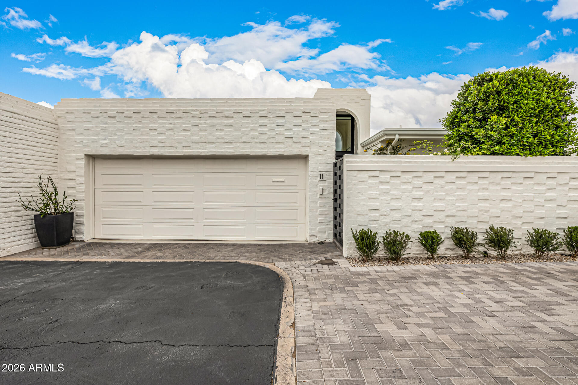 7770 East Camelback Road, Unit 11 Scottsdale, AZ 85251 - Photo 59 of 60 a front view of a house with a yard