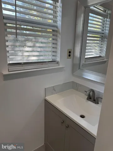 a bathroom with a sink and a window