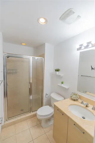 a bathroom with a toilet a sink and a mirror