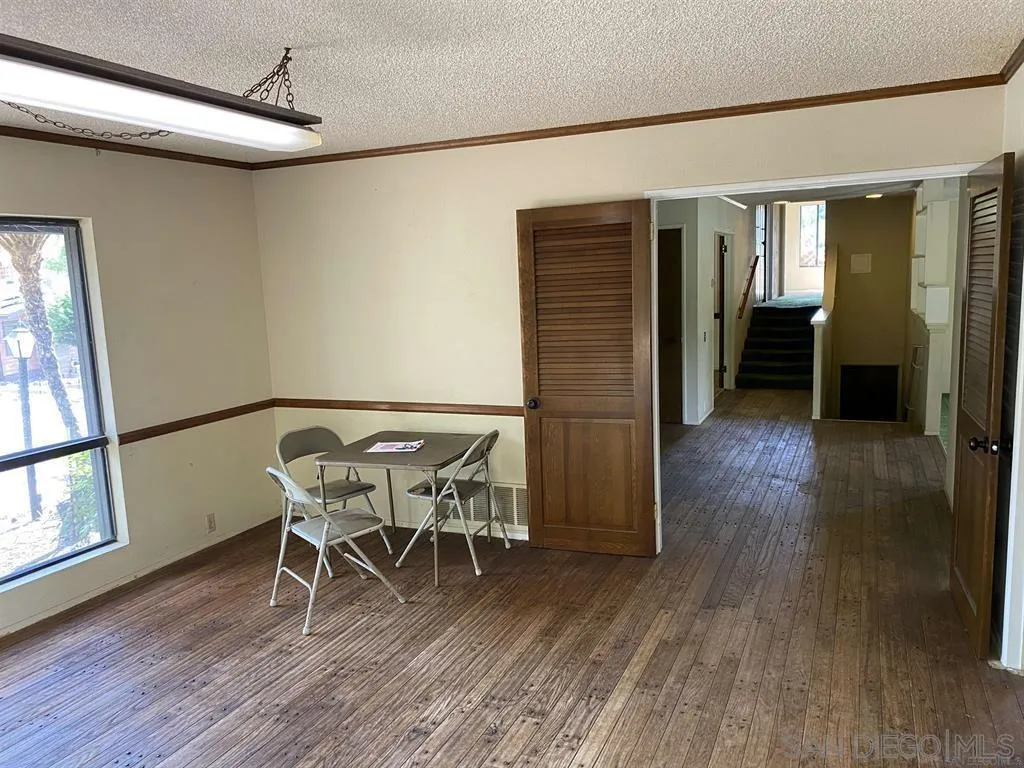 4940 Defiance Way San Diego, CA 92115 - Photo 23 of 47 a dining room with furniture and wooden floor