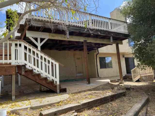 a view of deck with wooden floor and fence with a garden