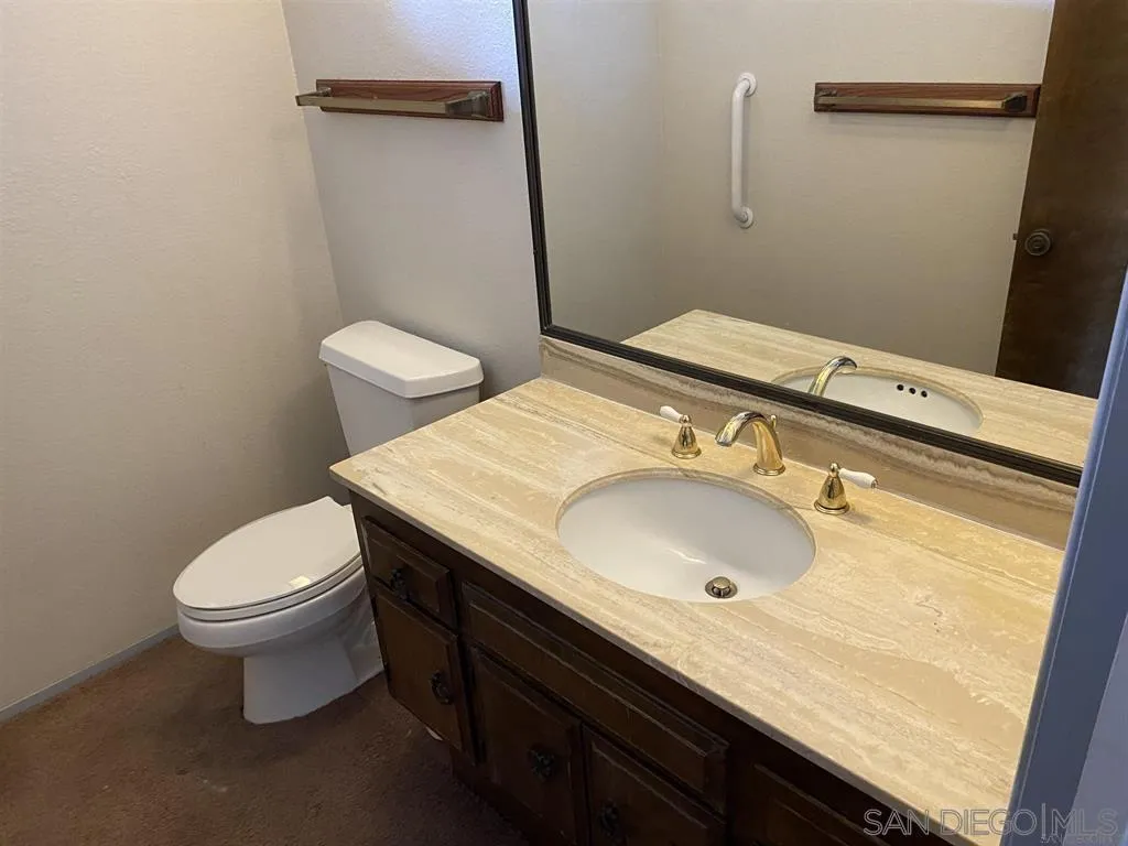 4940 Defiance Way San Diego, CA 92115 - Photo 5 of 47 a bathroom with a sink and a toilet