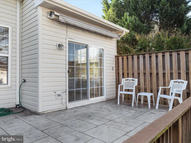 a view of a chairs and table in the back yard