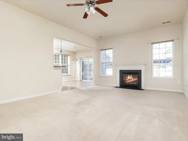 a view of empty room with a fireplace