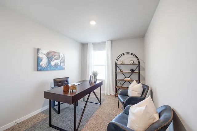 a workspace with furniture and a window