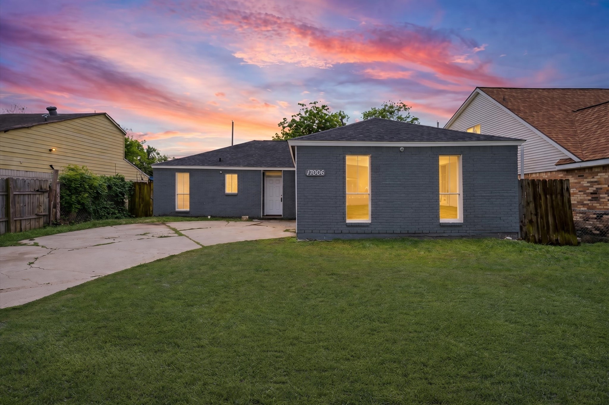 a front view of a house with a garden