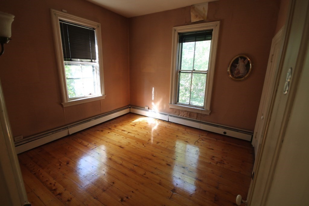52 Mattoon Street Springfield, MA 01105 - Photo 14 of 29 an empty room with wooden floor and windows