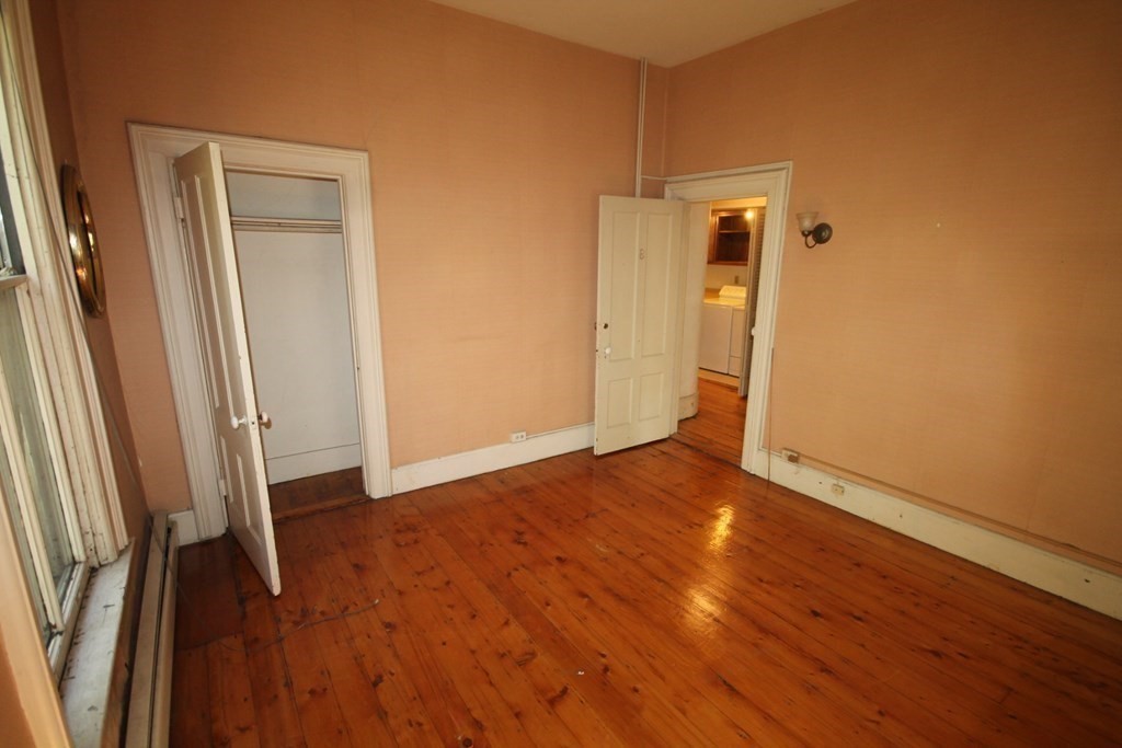 52 Mattoon Street Springfield, MA 01105 - Photo 15 of 29 a view of an empty room with wooden floor and a window