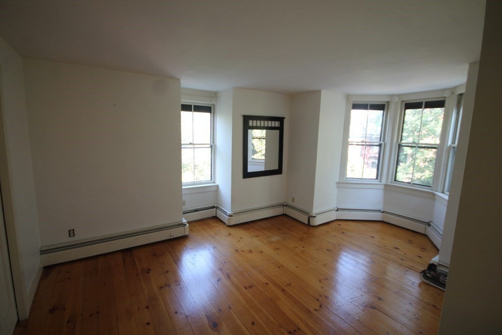 52 Mattoon Street Springfield, MA 01105 - Photo 18 of 29 an empty room with wooden floor and windows