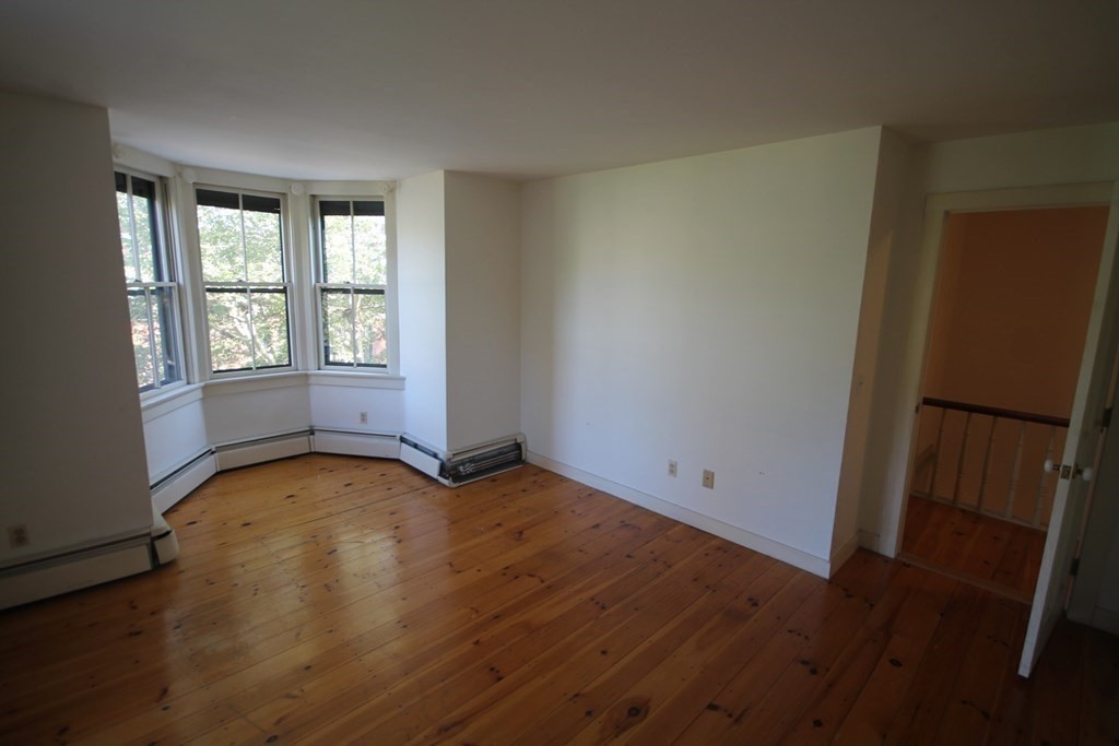 52 Mattoon Street Springfield, MA 01105 - Photo 19 of 29 an empty room with wooden floor and windows