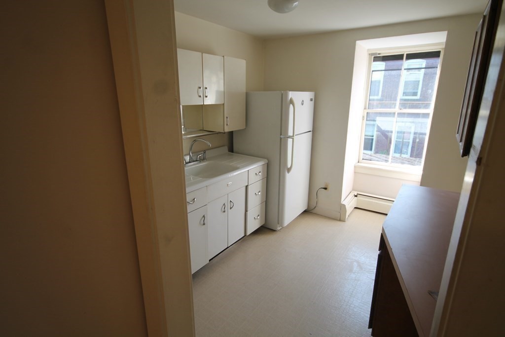 52 Mattoon Street Springfield, MA 01105 - Photo 23 of 29 a view of a bathroom with a sink cabinet and a window