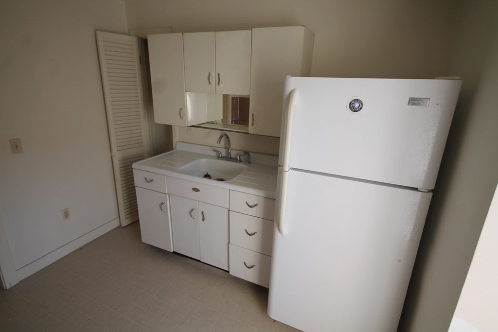 52 Mattoon Street Springfield, MA 01105 - Photo 24 of 29 a utility room with cabinets washer and dryer