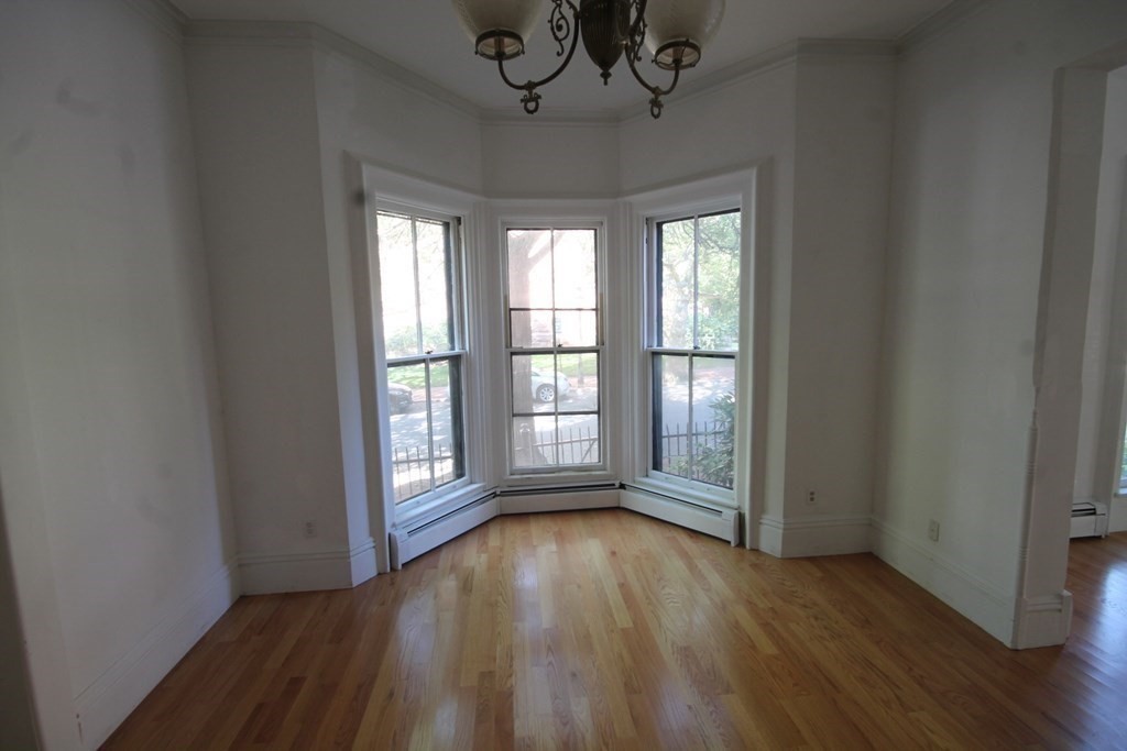52 Mattoon Street Springfield, MA 01105 - Photo 26 of 29 a view of an empty room with wooden floor and a window
