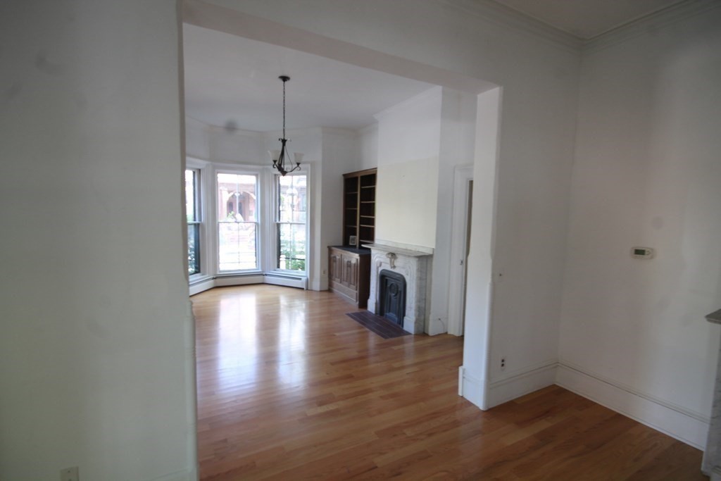 52 Mattoon Street Springfield, MA 01105 - Photo 5 of 29 a view of a room with wooden floor and a window