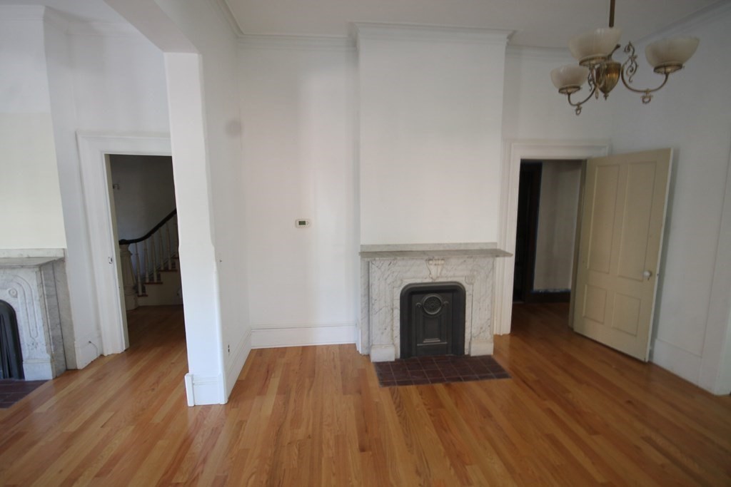 52 Mattoon Street Springfield, MA 01105 - Photo 7 of 29 a view of a livingroom with wooden floor and a fireplace