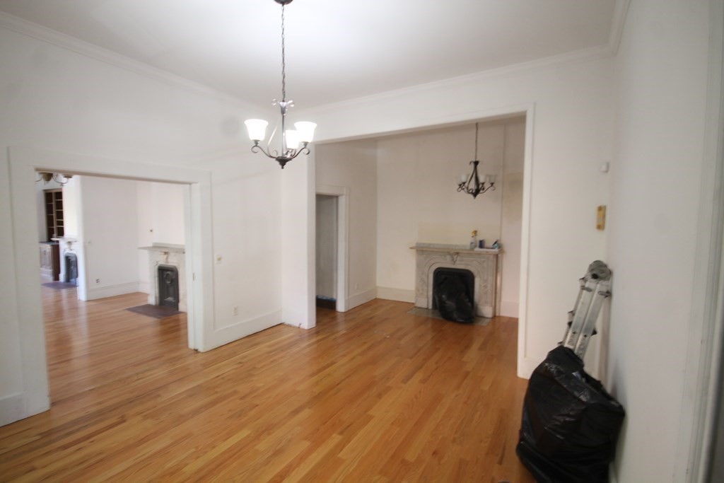 52 Mattoon Street Springfield, MA 01105 - Photo 8 of 29 a view of a livingroom with wooden floor and a ceiling fan