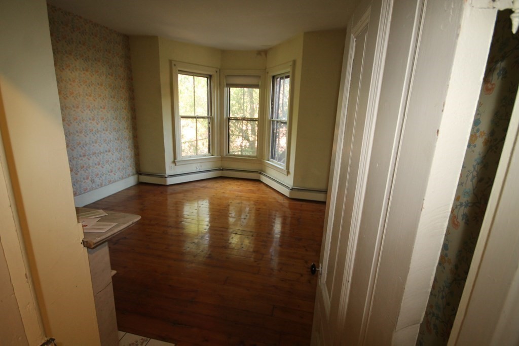 52 Mattoon Street Springfield, MA 01105 - Photo 9 of 29 a view of empty room with wooden floor and fan