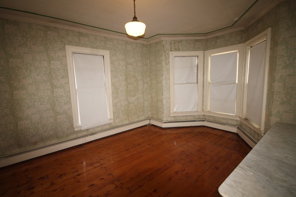 52 Mattoon Street Springfield, MA 01105 - Photo 10 of 29 a view of an empty room with window and wooden floor