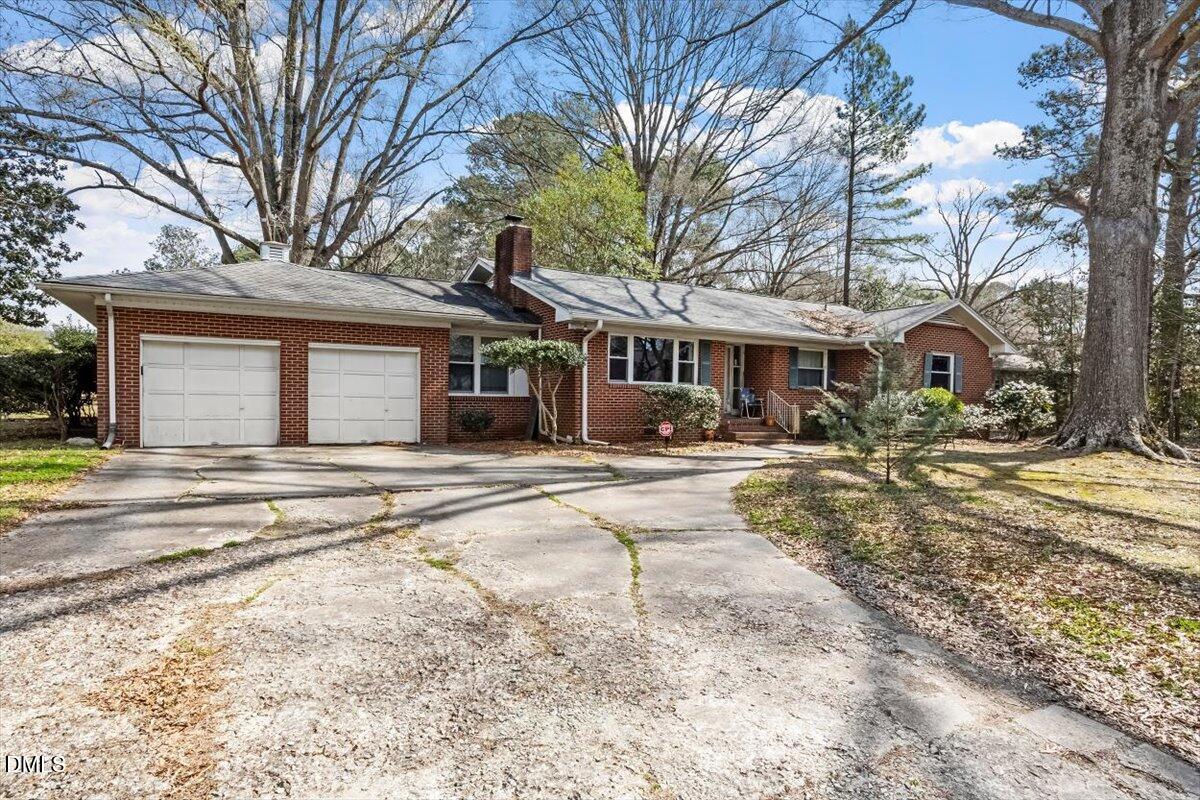 3107 Dixon Road Durham, NC 27707 - Photo 2 of 12 a front view of a house with a yard and garage