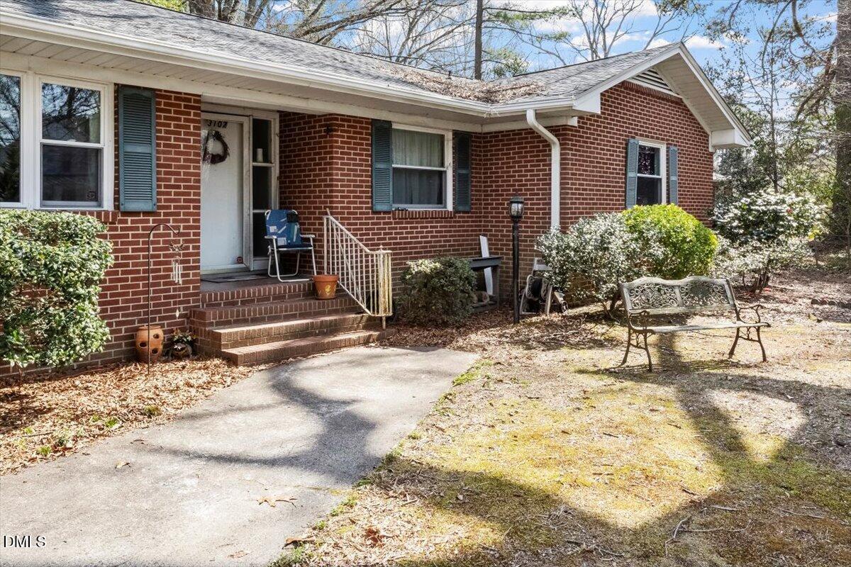 3107 Dixon Road Durham, NC 27707 - Photo 3 of 12 a view of house with yard and sitting area