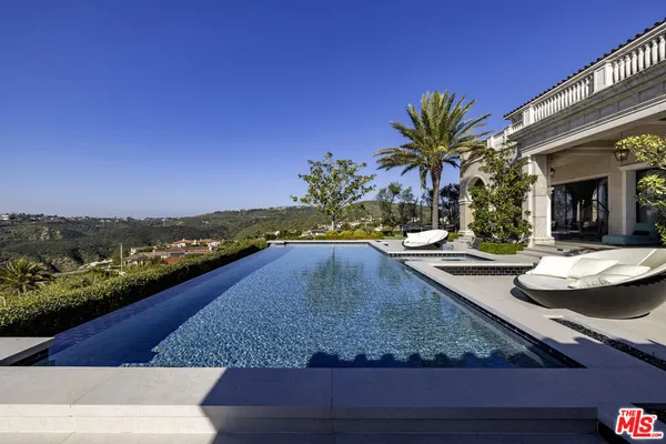 a view of a swimming pool with an outdoor seating