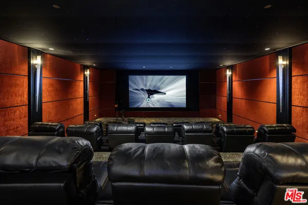 a room with furniture projector and screen