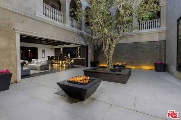 a view of a chairs and fire pit in the patio