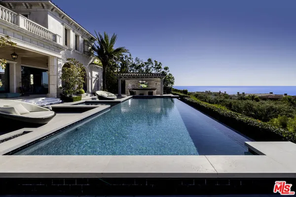 a view of a swimming pool with outdoor seating